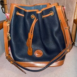 Navy blue and brown cinch closure Downey and Bourke hobo style purse.
